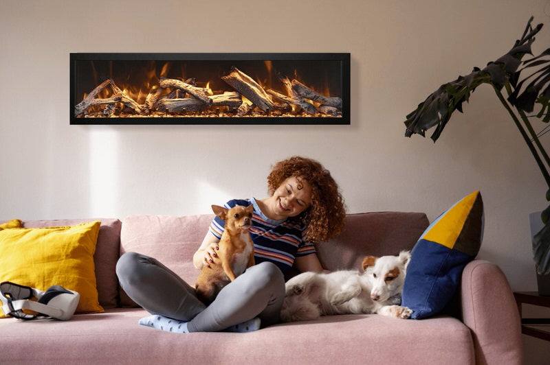 amantii panorama deep electric fireplace installed in living room with woman and two dogs