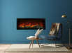 amantii symmetry bespoke extra tall electric fireplace installed in a blue wall next to a chair