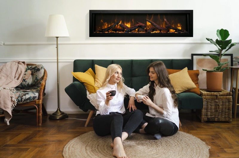 amantii panorama deep xt electric fireplace installed in living room with two women in front