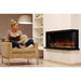 modern flames landscape pro multi 3 sided smart electric fireplace installed in living room next to a woman reading a book