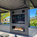 the bio flame 72-inch single sided built-in ethanol burner fireplace installed outside in a patio beneath a tv