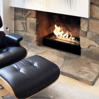 The bio flame 16-inch ethanol burner fireplace insert kit installed in existing fireplace next to leather chair
