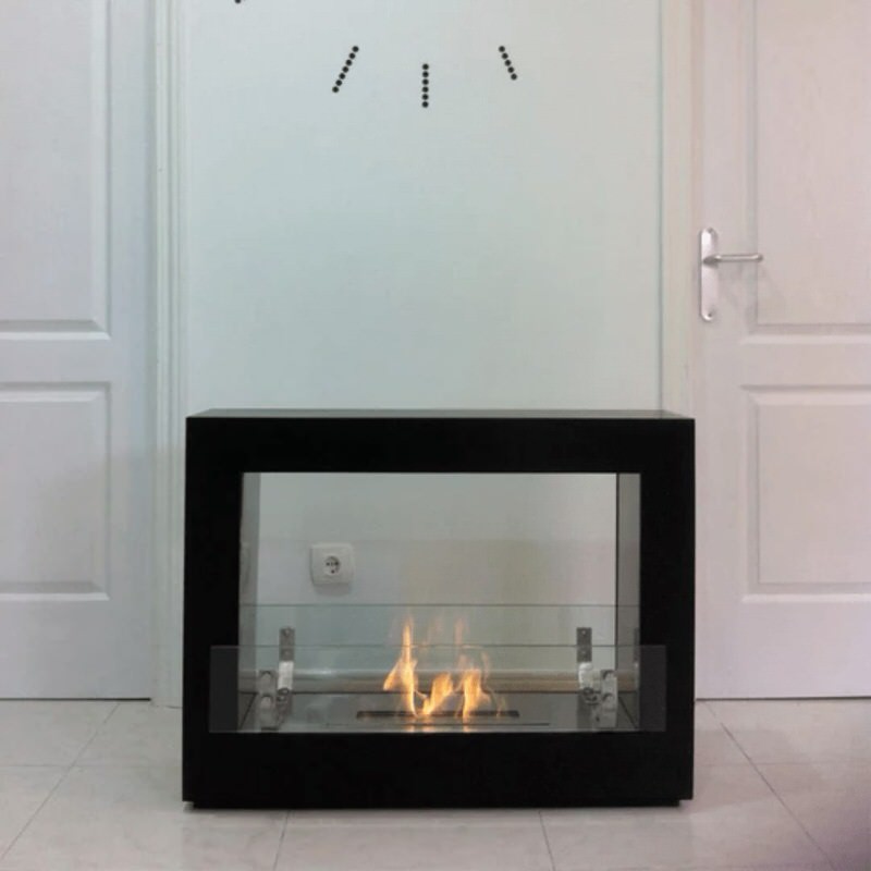 The bio flame rogue 2.0 36-inch free standing see-through ethanol fireplace installed in hallway in black finish under clock